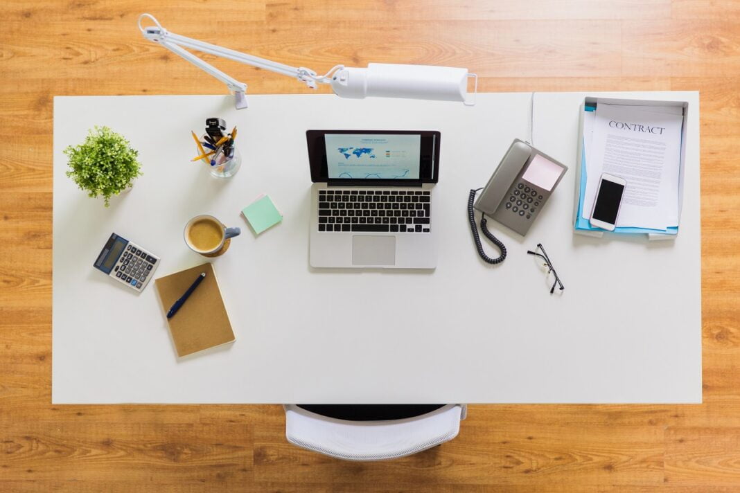 laptop, phone and other office stuff on table