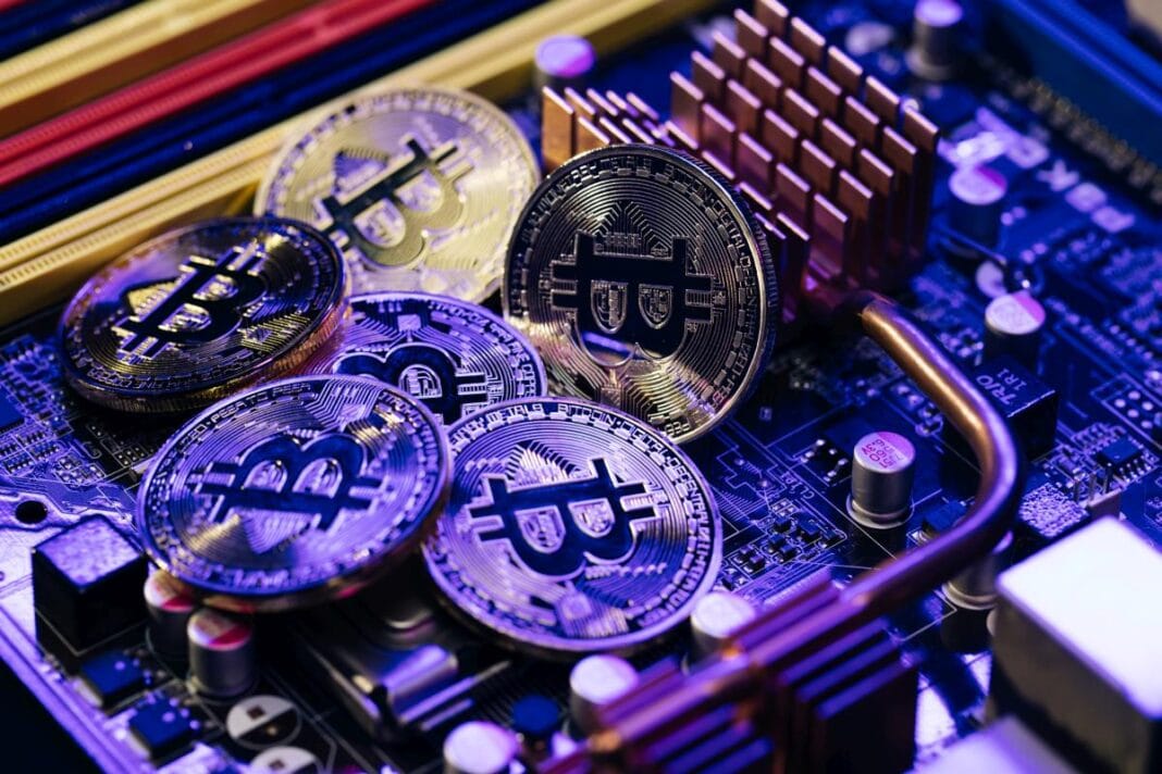 Crypto currency, bitcoin. BTC, Bit Coin. Blockchain technology, bitcoin mining. Close up shot of Bitcoins coins isolated on motherboard background