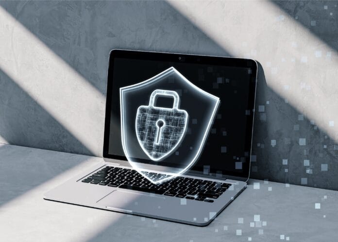 Close up of laptop computer on desktop with glowing padlock hologram on concrete background. Secure, safety and web concept. 3D Rendering.